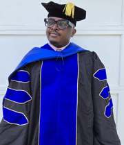 Dr. Marcelius Atanga wearing academic regalia