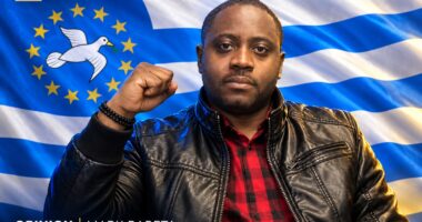 Designed editorial portrait of Mark Bareta raising his fist against an Ambazonia flag backdrop.
